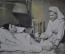 Фотография для газеты "Медсестра Кононова кладет парафин больному, мастеру Чучину". Февраль 1947 г.